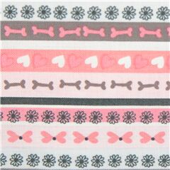 Tissu en coton rose avec des ranges d'os, de fleurs, de coeurs Tissu par Michael Miller