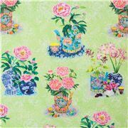 Tissu vert avec des fleurs arc-en-ciel et des vases à motifs
