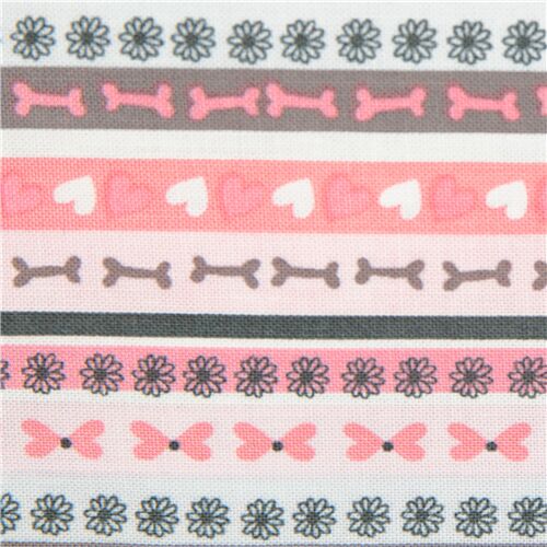Tissu en coton rose avec des ranges d'os, de fleurs, de coeurs Tissu