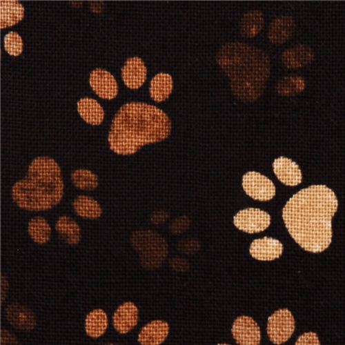 black animal fabric with brown paw prints dog Fabric by Timeless